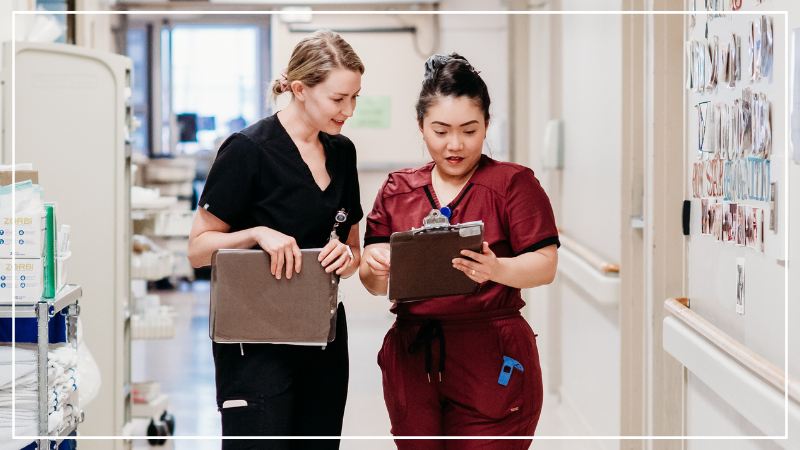 Photo of two nurses on a unit.